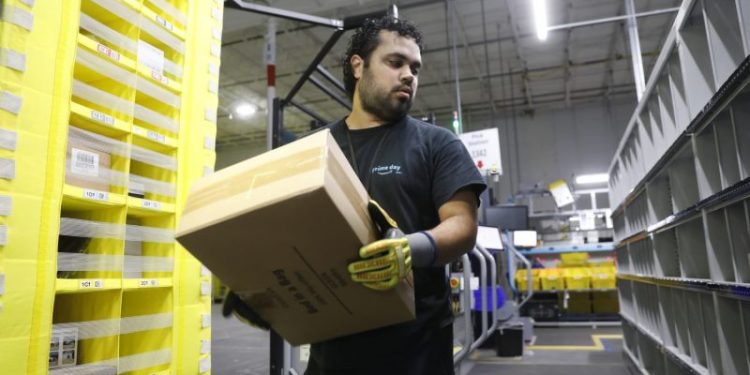 Amazon increases average pay for warehouse workers and adds free Prime membership perk